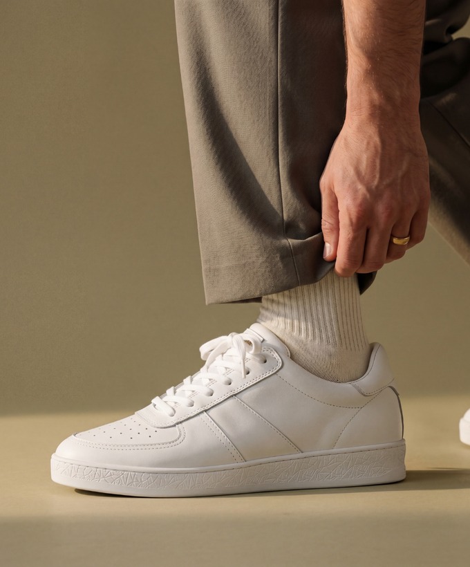 CTRNE white Geode sneaker styled with taupe trousers.